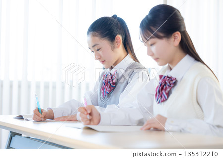 Junior high school girls studying at cram school 135312210