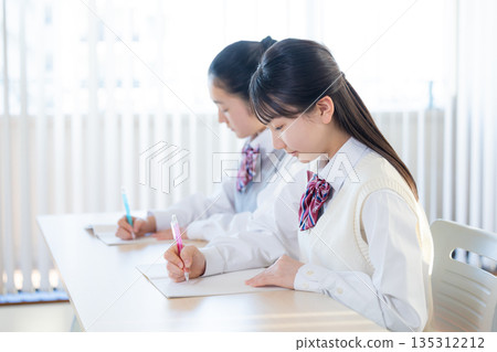 Junior high school girls studying at cram school Junior high school girls studying at cram school 135312212