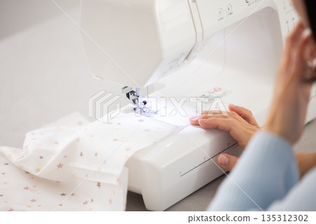 Close-up of a woman's hands sewing Close-up of a woman's hands sewing 135312302