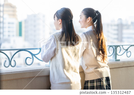 After school, a female junior high school student looks out from the school balcony After school, a female junior high school student looks out from the school balcony 135312487
