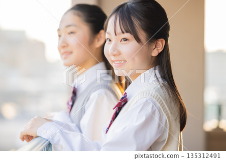 After school, a female junior high school student looks out from the school balcony After school, a female junior high school student looks out from the school balcony 135312491