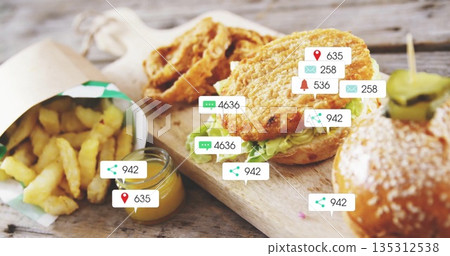 Displaying breaded chicken sandwiches with lettuce on wooden table, showing floating social icons Displaying breaded chicken sandwiches with lettuce on wooden table, showing floating social icons 135312538