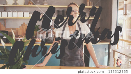 Barista in apron making espresso at wooden counter, with Christmas sign and pastries Barista in apron making espresso at wooden counter, with Christmas sign and pastries 135312565