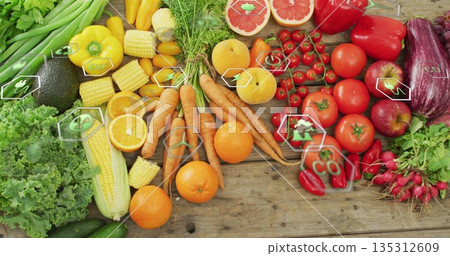Displaying wooden tabletop featuring fresh lettuce, avocado, tomatoes, carrots and eco icons 135312609