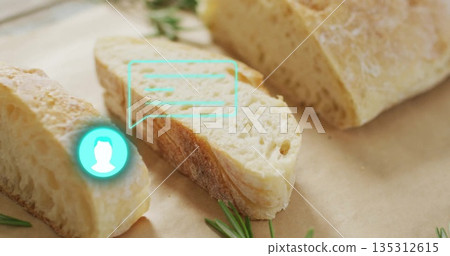 Displaying crusty bread slice on parchment on wooden countertop, with rosemary and turquoise icon Displaying crusty bread slice on parchment on wooden countertop, with rosemary and turquoise icon 135312615
