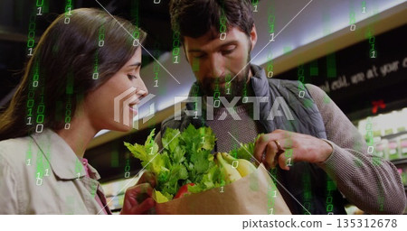 Examining couple holding grocery bag with lettuce bananas peppers in store aisle, binary overlay Examining couple holding grocery bag with lettuce bananas peppers in store aisle, binary overlay 135312678