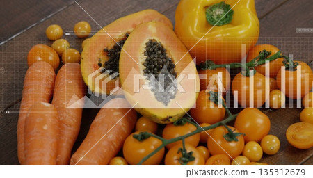 Showing carrots, papaya halves, bell pepper and cherry tomatoes on wooden table, with data overlays 135312679