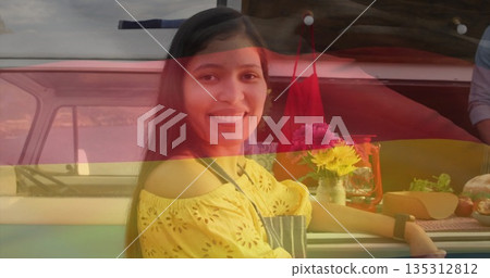 Leaning woman wearing yellow blouse and apron on countertop beside camper van at farmers market Leaning woman wearing yellow blouse and apron on countertop beside camper van at farmers market 135312812