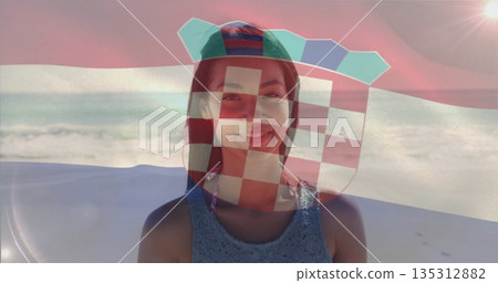Sitting woman wearing backward baseball cap and blue lace top on beach chair, with shield overlay Sitting woman wearing backward baseball cap and blue lace top on beach chair, with shield overlay 135312882