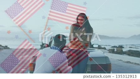 Kneeling man proposing to smiling woman on convertible trunk at coastal road, rocky shoreline 135312913