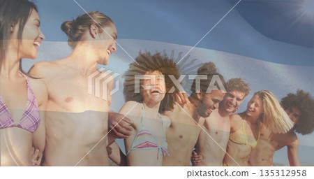 Laughing group of eight friends linking arms and gazing right on sandy beach, colorful swimwear Laughing group of eight friends linking arms and gazing right on sandy beach, colorful swimwear 135312958