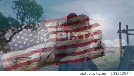 Giving piggyback ride man carrying partner in grassy park, flag overlay and slide ladder Giving piggyback ride man carrying partner in grassy park, flag overlay and slide ladder 135312974