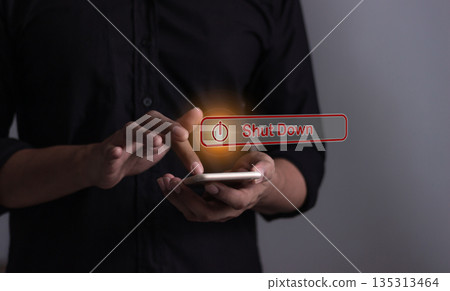 Young man with smartphone hand touching Shut Down button press power OFF 135313464