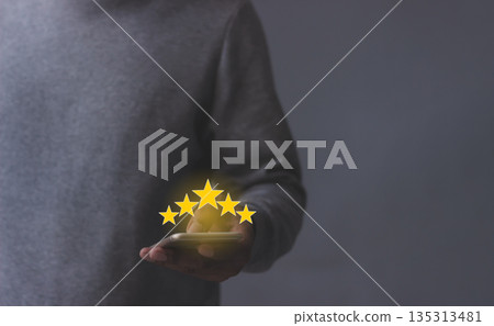 Excellence Review, Young Man hand holding Smart Phone with five star to review and give 5 stars with very good results in service, Good review 5 star rating choice feedback Excellence Review, Young Man hand holding Smart Phone with five star to review and give 5 stars with very good results in service, Good review 5 star rating choice feedback 135313481