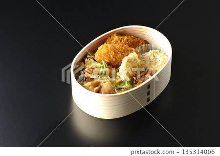 Mushroom rice and fried oyster bento photographed against a black background Mushroom rice and fried oyster bento photographed against a black background 135314006