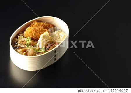 Mushroom rice and fried oyster bento photographed against a black background Mushroom rice and fried oyster bento photographed against a black background 135314007