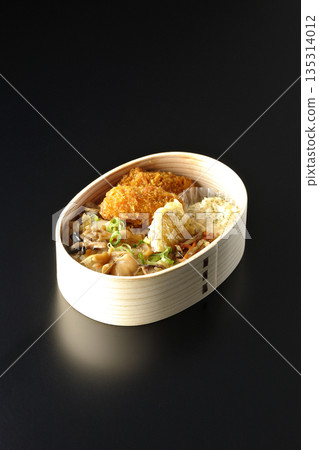 Mushroom rice and fried oyster bento photographed against a black background Mushroom rice and fried oyster bento photographed against a black background 135314012