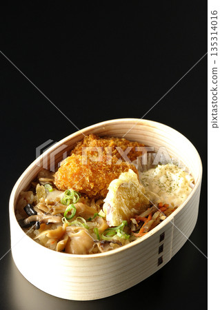 蘑菇飯和炸蠔便當,以黑色背景拍攝 蘑菇飯和炸蠔便當,以黑色背景拍攝 135314016