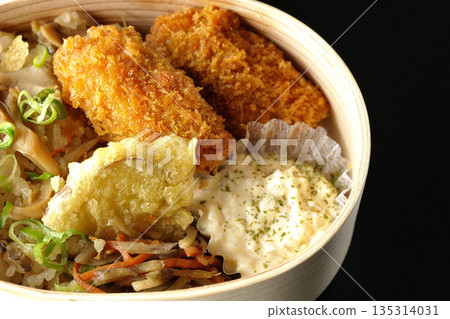 Mushroom rice and fried oyster bento photographed against a black background 135314031