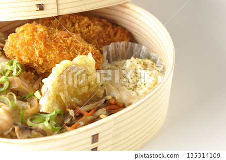 Mushroom rice and fried oyster bento photographed on a white background 135314109