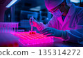 Researcher analyzing cell cultures in a sterile future 135314272