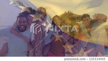 Posing friends piggybacking on beach with waves at sunset, with translucent American flag overlay Posing friends piggybacking on beach with waves at sunset, with translucent American flag overlay 135314445
