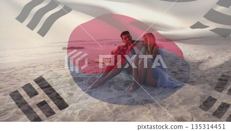 Couple wearing dress and board shorts sitting on beach at sunset with surfboard, two bottles Couple wearing dress and board shorts sitting on beach at sunset with surfboard, two bottles 135314451