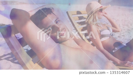 Relaxing adult couple sunbathing on beach lounge chairs, with striped bikini sunglasses and trunks Relaxing adult couple sunbathing on beach lounge chairs, with striped bikini sunglasses and trunks 135314607