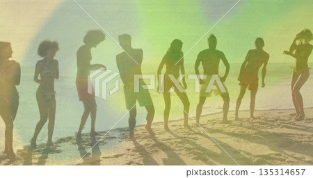 Eight adults wearing swimwear bending knees and raising arms in sandy shore, with light flares 135314657