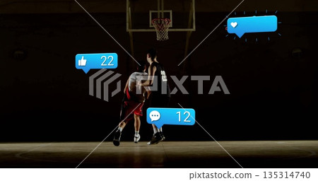 Dribbling basketball toward hoop, white dribbler facing defender on court with social media icons Dribbling basketball toward hoop, white dribbler facing defender on court with social media icons 135314740
