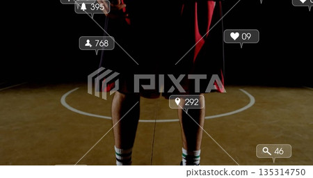Standing athlete lower body showing red shorts striped socks on basketball court with UI icons Standing athlete lower body showing red shorts striped socks on basketball court with UI icons 135314750