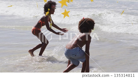 Splashing siblings diving in shallow ocean water at beach, with swim goggles and foamy waves Splashing siblings diving in shallow ocean water at beach, with swim goggles and foamy waves 135314811