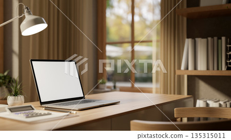 Blank screen laptop with calculator atop paper and lamp on wooden table and bookshelf in living room Blank screen laptop with calculator atop paper and lamp on wooden table and bookshelf in living room 135315011