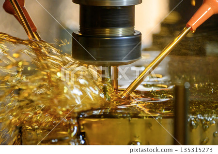 Close Up of CNC Milling Machine with Oil Coolant in Metal Machining Process 135315273