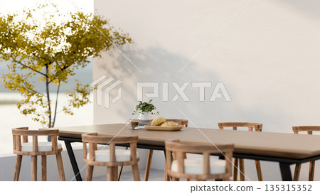 Bread and coffee aside potted plant on wooden table with chairs in dining area of cafe or restaurant Bread and coffee aside potted plant on wooden table with chairs in dining area of cafe or restaurant 135315352