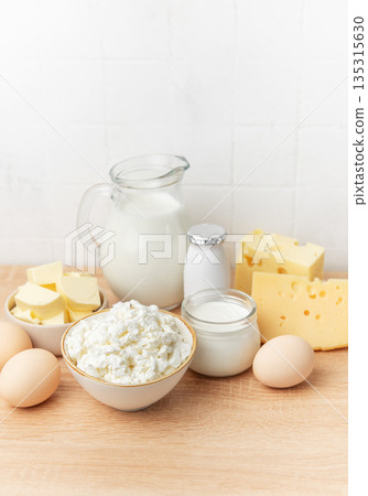 Assortment of fresh dairy products and eggs on wooden background Assortment of fresh dairy products and eggs on wooden background 135315630