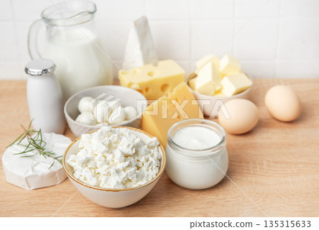 Assorted dairy products and fresh eggs on wooden background Assorted dairy products and fresh eggs on wooden background 135315633