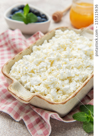 Cottage cheese in bowl with honey and blueberries breakfast Cottage cheese in bowl with honey and blueberries breakfast 135315636