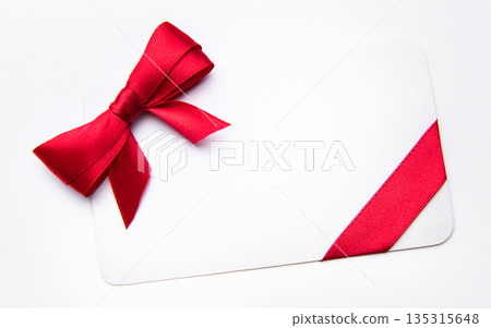 White card with red ribbon bow for celebration White card with red ribbon bow for celebration 135315648