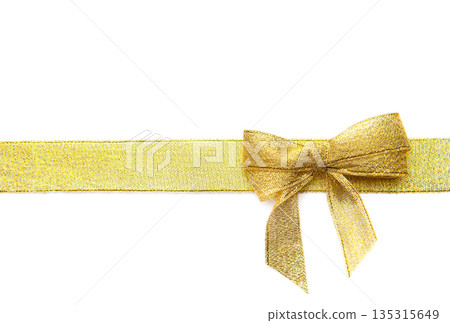 Golden ribbon with bow for festive gift wrapping Golden ribbon with bow for festive gift wrapping 135315649