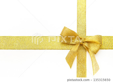 Gold ribbon bow creating a festive background decoration Gold ribbon bow creating a festive background decoration 135315650