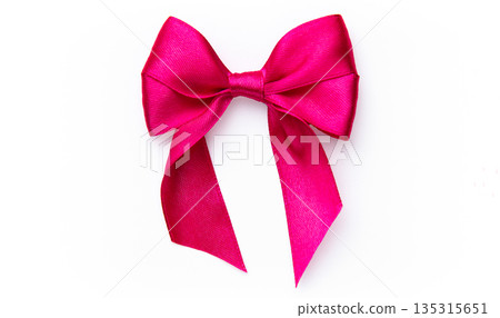 Pink satin ribbon creating a decorative bow Pink satin ribbon creating a decorative bow 135315651