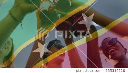 Toasting five friends raising red cups under striped flag in yard, with sunglasses and baseball cap Toasting five friends raising red cups under striped flag in yard, with sunglasses and baseball cap 135316228