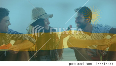 Eating watermelon slices, three friends wearing straw sunhat at seaside beach, summer picnic 135316233