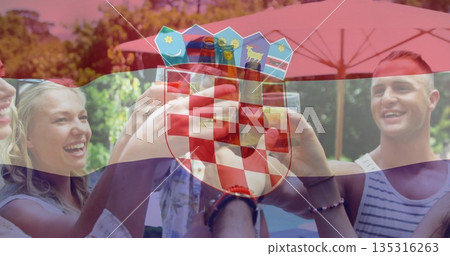 Four adults clinking beer bottles on patio near pool under red umbrella, with Croatian flag overlay 135316263
