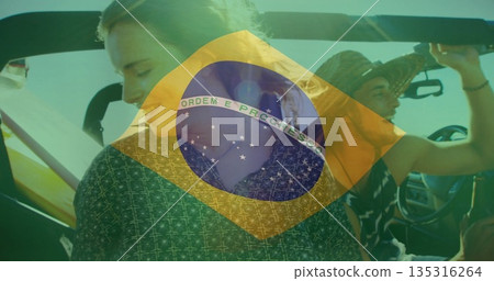Turning passenger and gripping driver in convertible sports car on road with Brazil flag overlay 135316264