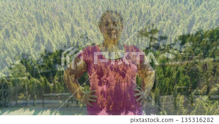 Leaning woman wearing pink Tshirt on wood railing overlooking mountain lake with pine tree overlay 135316282