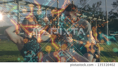 Performing sit-ups woman being assisted by man on grassy area with bars circuit-board overlay 135316402