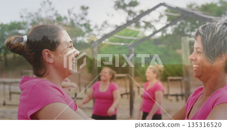 Holding forearms, women in pink tops, leggings warming up on sand at calisthenics park, copy space Holding forearms, women in pink tops, leggings warming up on sand at calisthenics park, copy space 135316520