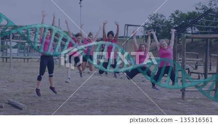 Leaping six partners wearing pink tops, black bottoms on park obstacle course, with green DNA model 135316561